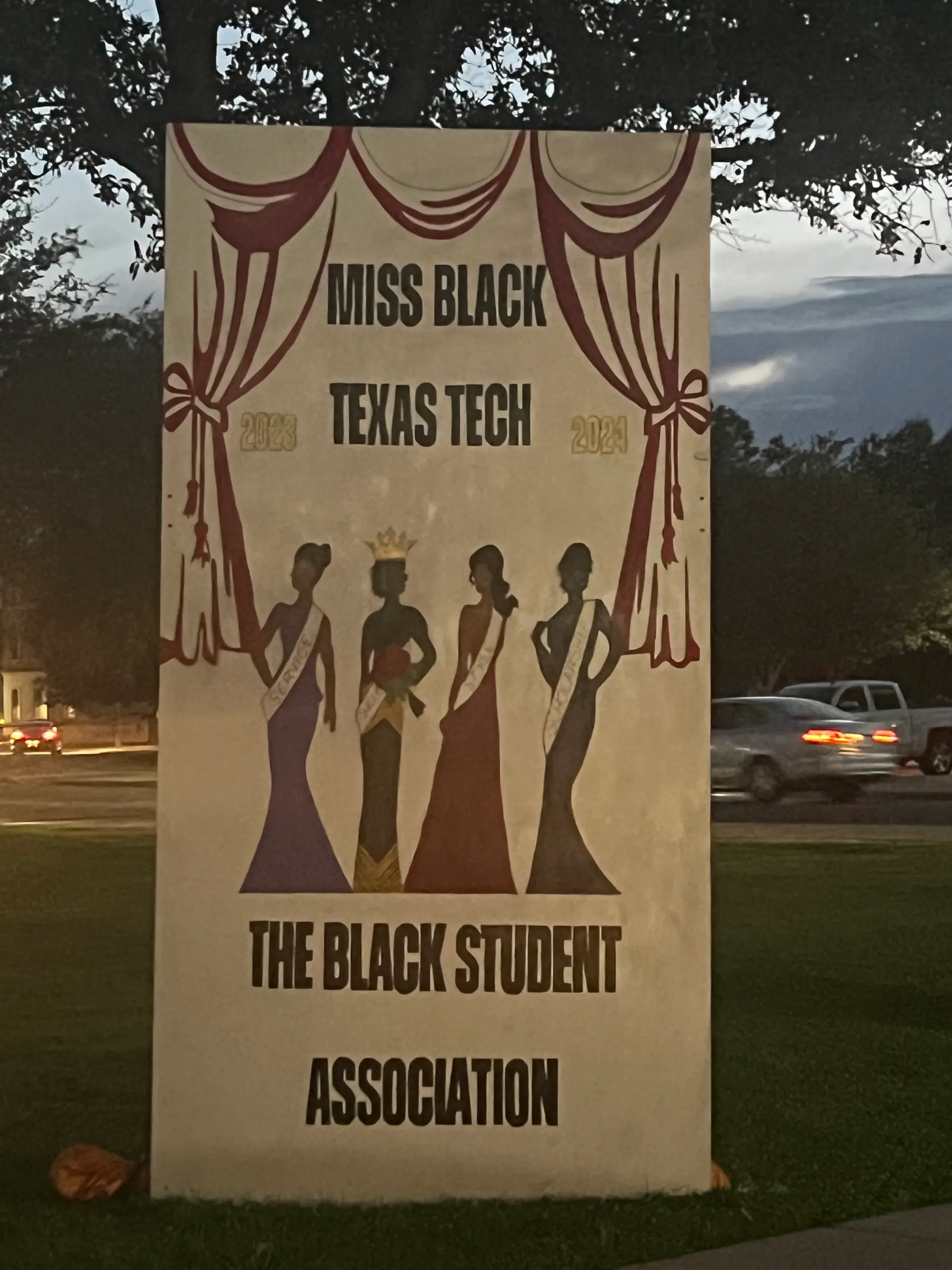 Painted board: Miss Black Texas Tech 2023-2024, The Black Student Association, curtains and four gowned figures